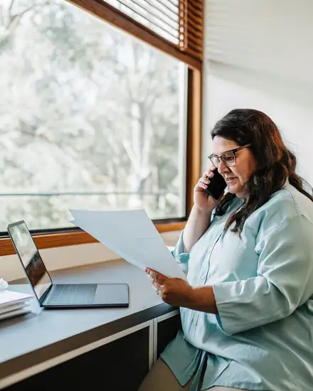 Support coordinator reviewing a participant's plan by phone